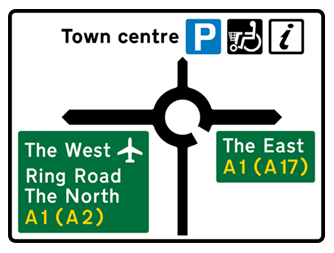 Green road sign with white, black and orange text showing destinations, directions and parking