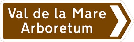 Brown road sign with white text showing destination and direction