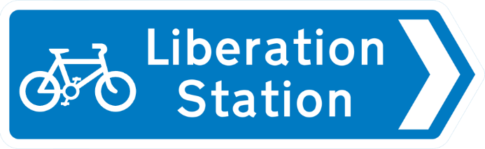 Blue road sign with image of bicycle and white text showing destination and direction